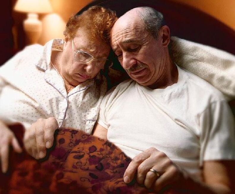 pair of elderly in bed
