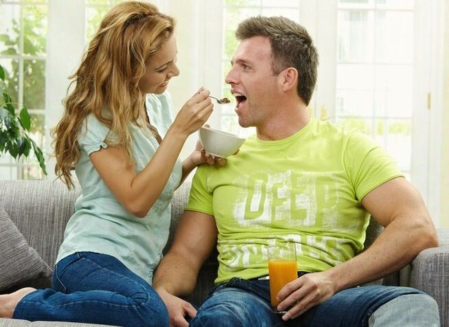 woman feeds man with products to increase potency